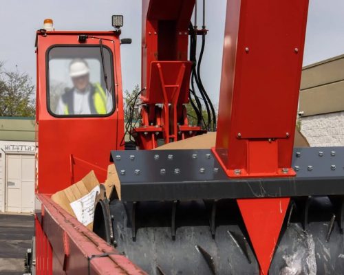 Waste compaction truck providing service