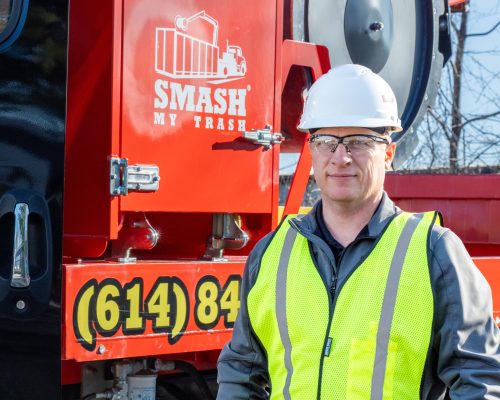 A licensed and insured Smash Truck® operator wearing safety equipment, demonstrating a commitment to reduce workplace injuries.